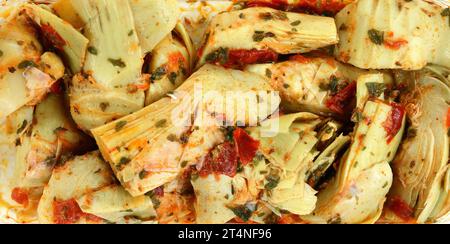 artichokes salad with vegetable mix sauce dressing background. Stock Photo