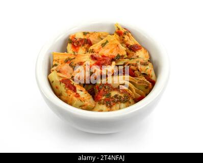 artichokes salad with vegetable mix sauce dressing in a bowl isolated on white background. Stock Photo