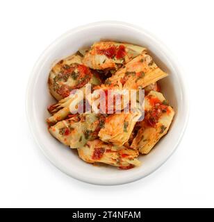 artichokes salad with vegetable mix sauce dressing in a bowl isolated on white background. Stock Photo