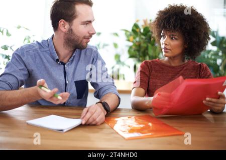 In my opinion...two design professionals having a discussion while seated at a table. Stock Photo