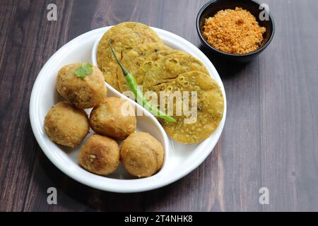 Dry Kachori is a deep fried crispy and crunchy balls of maida flour, stuffed with spicy mix of gram flour, sev, Lentils, Tamarind chutney. Stock Photo