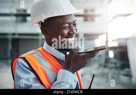 Business hours are for building customer relationships. a young man using a smartphone while working at a construction site. Stock Photo