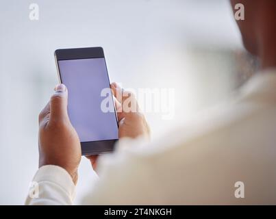 Its great to be connected wherever I go. an unrecognizable businessperson using a phone at work. Stock Photo