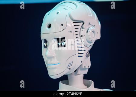 Closeup of white illuminated human robot looking away against blurred background Stock Photo