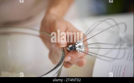 Where the action happens. Closeup shot of a woman using baking utensils in a kitchen. Stock Photo