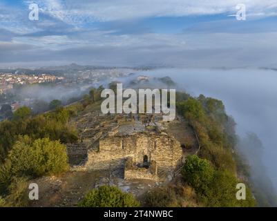 Aerial view of the archaeological site of L'Esquerda, in Roda de Ter, on a foggy sunrise (Osona, Barcelona, Catalonia, Spain) Stock Photo