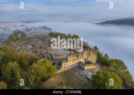 Aerial view of the archaeological site of L'Esquerda, in Roda de Ter, on a foggy sunrise (Osona, Barcelona, Catalonia, Spain) Stock Photo