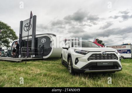 Nantwich, Cheshire, England, July 26th 2023. White Toyota RAV4 at an event display, automotive and lifestyle editorial illustration. Stock Photo
