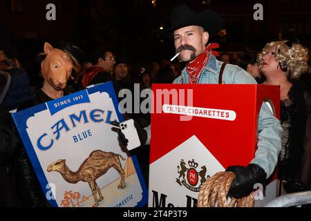 A couple dressed as two packs of cigarettes pose for a photo before the Greenwich Village Halloween Parade in New York, Oct. 31, 2023. (Photo: Gordon Donovan) Stock Photo