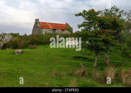 An old, rusty tin roof cottage near Maam Cross, Connemara, Galway, Ireland. Stock Photo