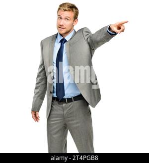 Youre fired. a handsome young businessman standing alone in the studio and pointing in anger. Stock Photo