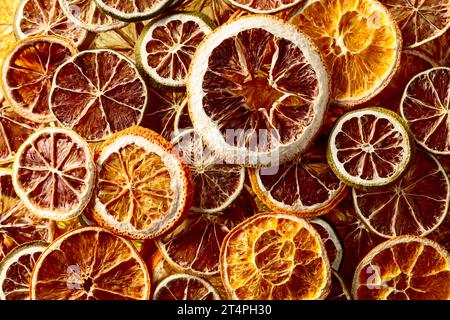 Dried citrus background. Dehydrated crispy fruit slices. Top view. Stock Photo