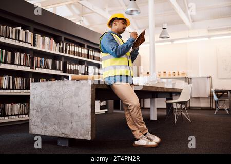 Proper planning is how you make a success of anything. an architect making notes while standing in his office. Stock Photo
