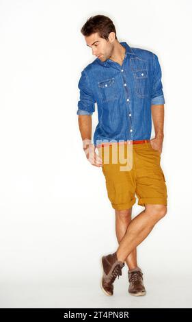 Fashion, clothes and natural with a man in studio on a white background for trendy hipster style. Model, casual and cool with a confident young person Stock Photo