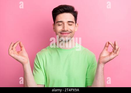 Photo of young buddha prayer guy closed eyes balancing meditating relaxed after office working days isolated on pink color background Stock Photo