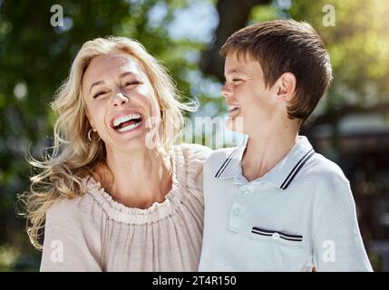 My son is quite a jokester. a woman spending time outdoors with her young son. Stock Photo