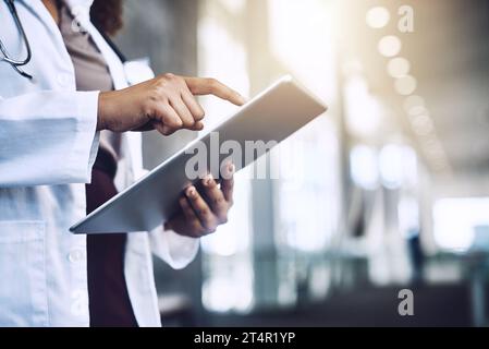 Tapping into the future of healthcare. an unrecognizable doctor using a digital tablet. Stock Photo
