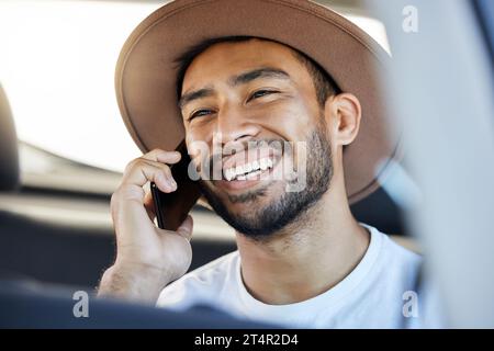 Healthy, free, the world before me. a young man sitting in a car while using his phone. Stock Photo
