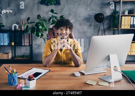 Photo of successful nice man hacker dressed stylish clothes sitting in his workspace modern office indoors Stock Photo