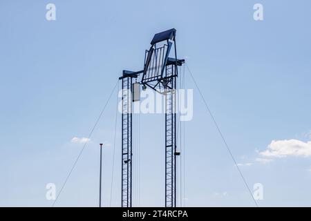 Shooting target on mooring post or Schietboom with 18 wooden stops on a shooting range against blue sky background, Buksschieten, shooting diagonally Stock Photo