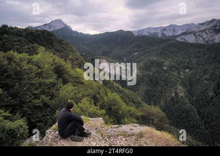 man looking mountains covered by forest of Perucica Primeval Rainforest in Sutjeska National Park, Bosnia and Herzegovina (2) Stock Photo