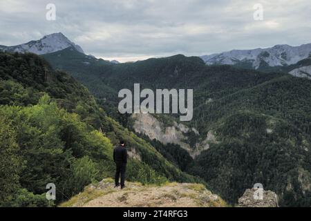 man looking mountains covered by forest of Perucica Primeval Rainforest in Sutjeska National Park, Bosnia and Herzegovina Stock Photo