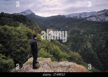 man looking mountains covered by forest of Perucica Primeval Rainforest in Sutjeska National Park, Bosnia and Herzegovina Stock Photo