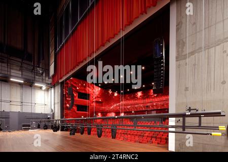 Large auditorium (grote zaal) seen from rear of stage, with raised stage curtain and lighting rig. Theater Zuidplein, Rotterdam, Rotterdam, Netherland Stock Photo