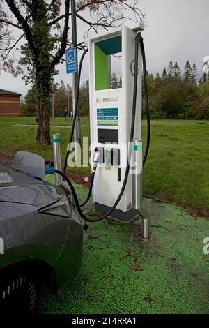 Nissan Lead  electric car charging at bank of chargers in rest area of Mootorway Service Sation Junction 47 on the M4 part of Gridserve Electric Highw Stock Photo
