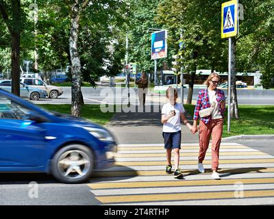 Danger of using smartphone by pedestrians on the road Stock Photo