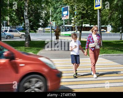 Danger of using smartphone by pedestrians on the road Stock Photo