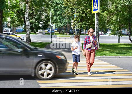 Danger of using smartphone by pedestrians on the road Stock Photo