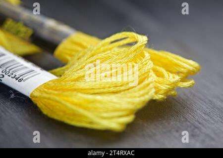 Yellow yarn on a black background seen up  close Stock Photo