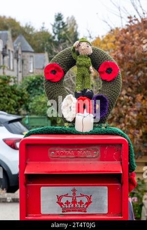 Nairn, Highlands and Islands, UK. 1st Nov, 2023. This is a knitted Woolen Lest We Forget Emblem on a Post Box in Nairn Town Centre. Credit: JASPERIMAGE/Alamy Live News Stock Photo