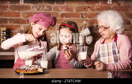 Smiling Grandmother With Daughter And Granddaughters Cook Christmas 