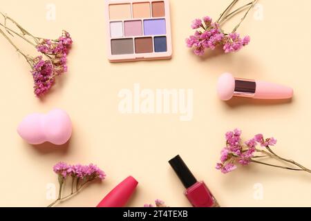 Frame made of makeup products and beautiful gypsophila flowers on beige background Stock Photo