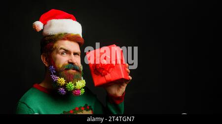 Delivery man in protective mask, gloves and santa's hat holding