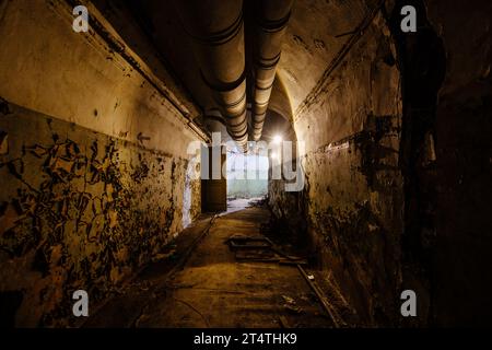 Old vaulted corridor of Soviet bunker, echo of Cold War. Stock Photo
