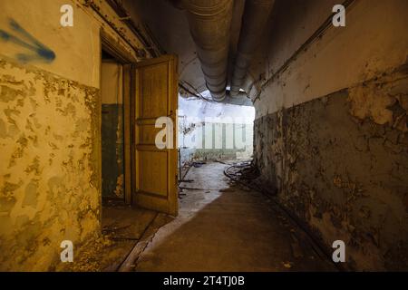 Old vaulted corridor of Soviet bunker, echo of Cold War. Stock Photo
