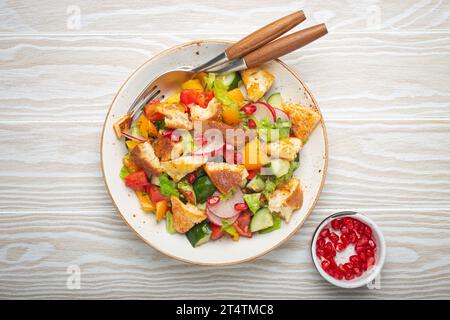 Traditional Levant dish Fattoush salad, Arab cuisine, with pita bread croutons, vegetables, herbs. Healthy Middle Eastern vegetarian salad, rustic Stock Photo