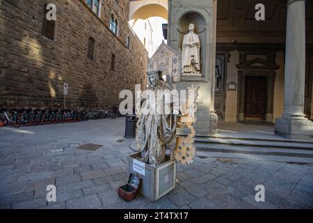 Florence, Italy: A street performer on the premises of Uffizi Gallery in Piazzale degli Uffizi in Florence. Italy Stock Photo