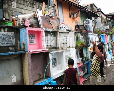 Caloocan, Philippines. 01st Nov, 2023. People seen at the cemetery despite heavy downpours. People flock to Sangandaan Cemetery to observe UNDAS or All Saints Day in Caloocan City despite heavy downpours to visit their departed loved ones. The Philippine National Police (PNP) Caloocan were deployed outside the cemetery ensuring the order and safety of the public. Credit: SOPA Images Limited/Alamy Live News Stock Photo