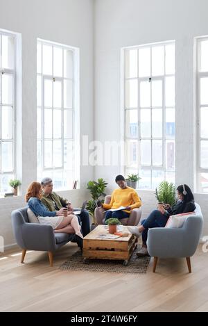 Startup, meeting and creative employees in the office lounge or coworking space planning a project in collaboration. Teamwork, diversity and team Stock Photo