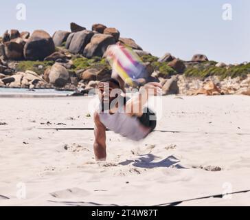 Sports, beach and man playing volleyball while jumping on the sand while on tropical weekend trip. Fitness, blur motion and young male athlete Stock Photo