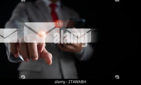 Businessman hand touching email on virtual screen. New email notification concept for business email communication and digital marketing. The inbox re Stock Photo