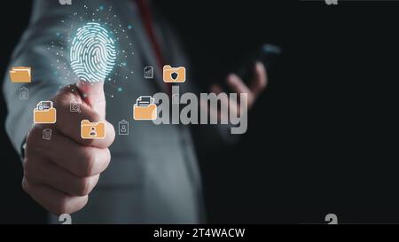 Businessman using fingerprint scanner to log in showing cyber security protection and data security concept including secure login Stock Photo