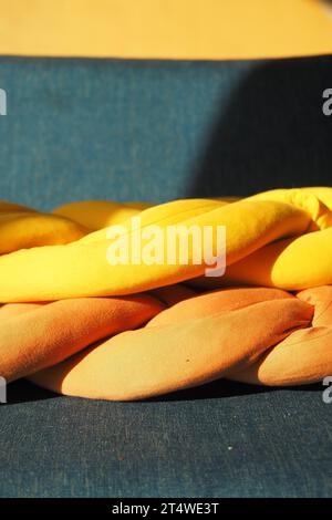 yellow and orange color pillows on a sofa  Stock Photo