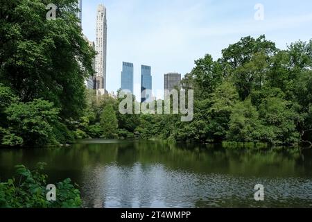 View of Manhanttan skyline as seen from the Pond, one of seven bodies of water in Central Park, located near Grand Army Plaza, Central Park South Stock Photo