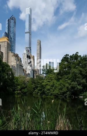 View of Manhanttan skyline as seen from the Pond, one of seven bodies of water in Central Park, located near Grand Army Plaza, Central Park South Stock Photo