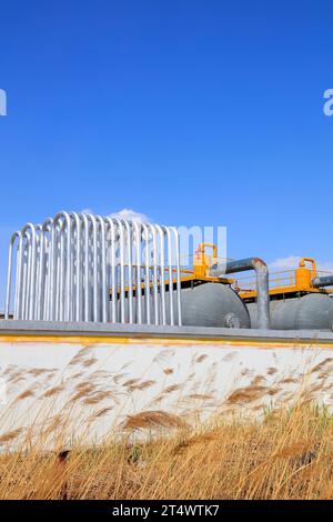 Silver metal radiator and storage tanks under blue sky Stock Photo - Alamy